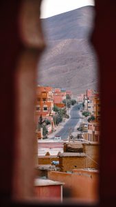 Desert town with colorful buildings and mountain backdrop.