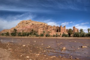 a large brown building sitting on top of a hill