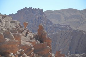 a man standing on top of a rock formation